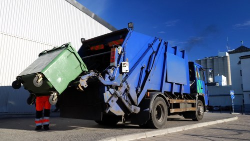 Service vehicle and bins at a commercial site