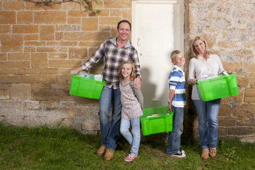 Collection crew managing segregated recycling bins for businesses